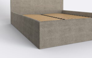 Tapicerowany bok łóżka sypialnianego w szaro beżowym kolorze.