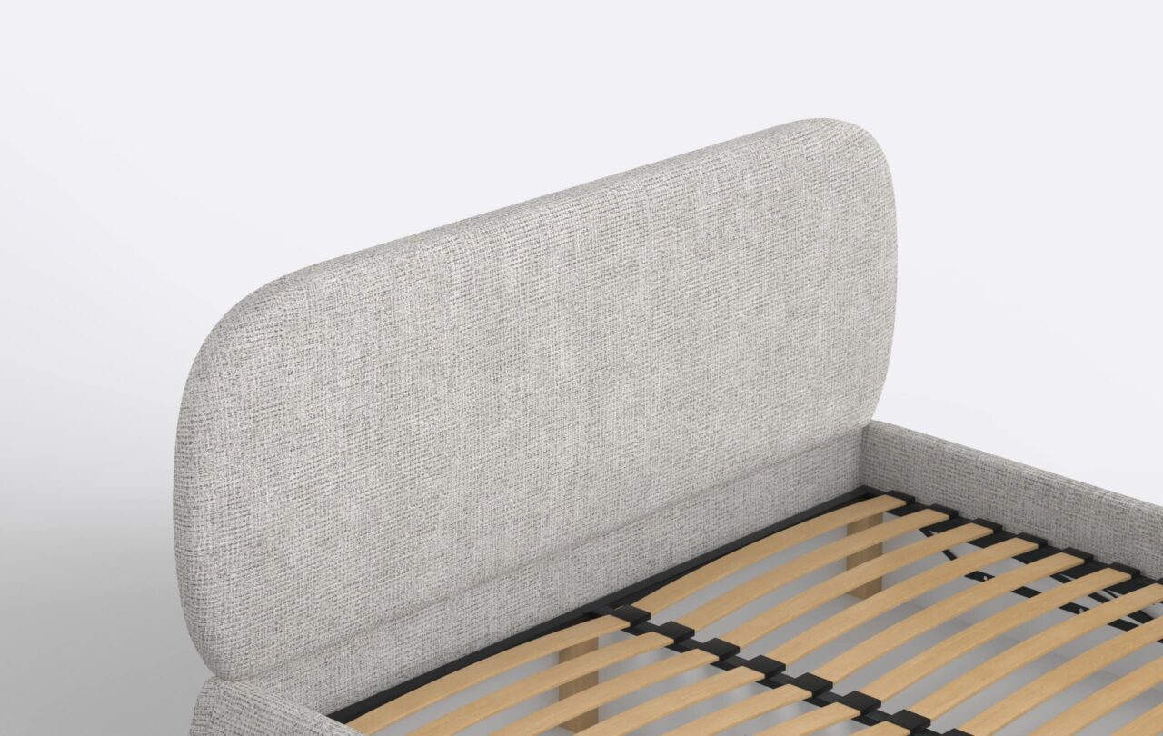 Nowoczesne łóżko tapicerowane w szarym odcieniu.