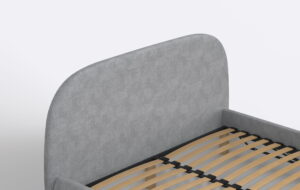 Nowoczesne łóżko tapicerowane z obłym zagłówkiem.