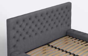 Łóżko z pikowanym zagłówkiem i pojemnikiem na pościel.