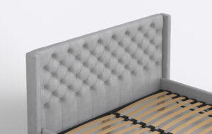 Szare łóżko do sypialni z pikowanym zagłówkiem.