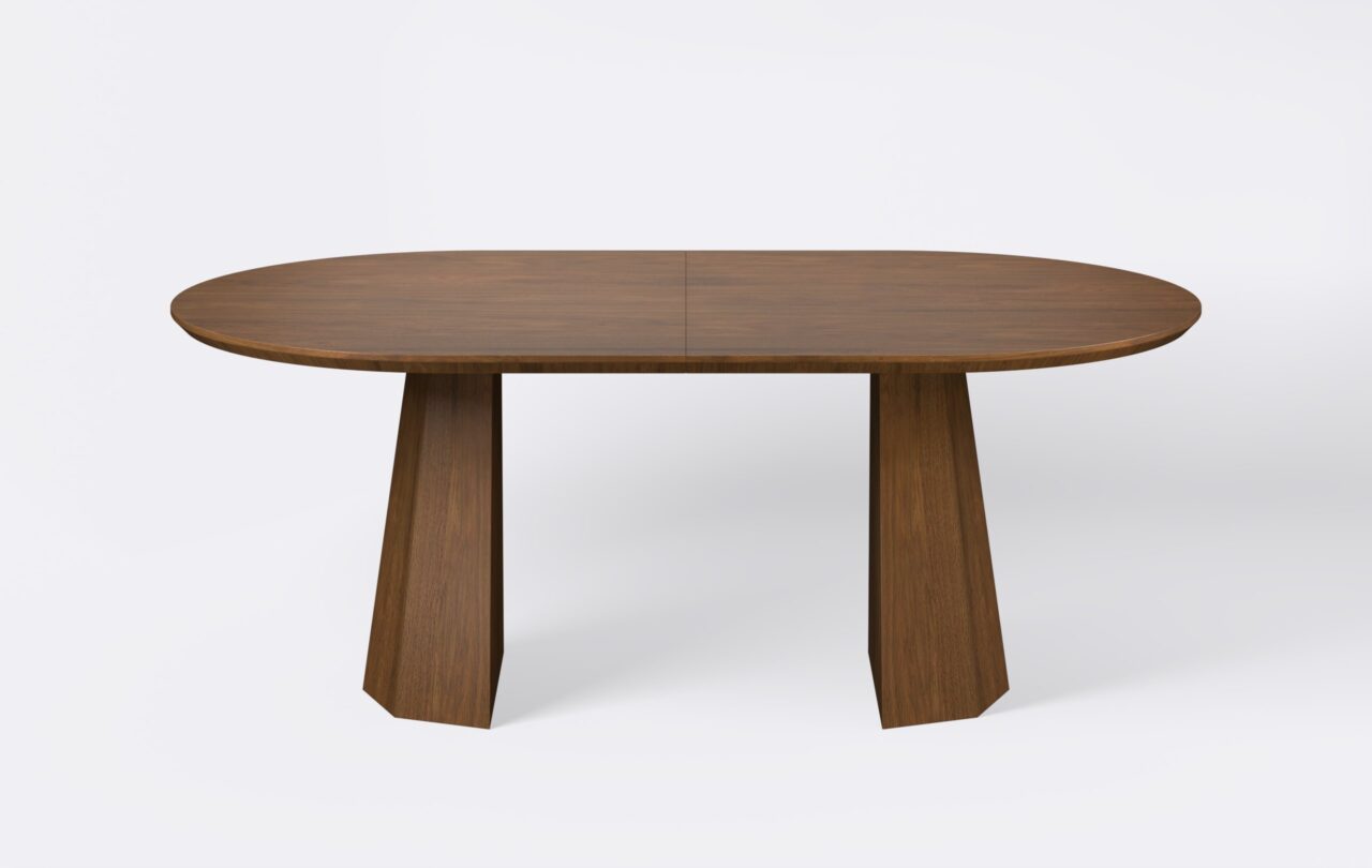 Owalny stół z funkcja rozkładania, na dwóch nogach, fornirowany, o wybarwieniu ciemnego dębu.