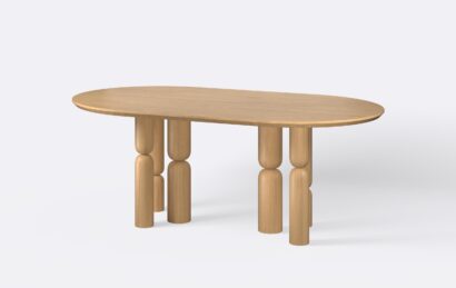 Obły stół na sześciu nogach, wykończony w stylu japandi.