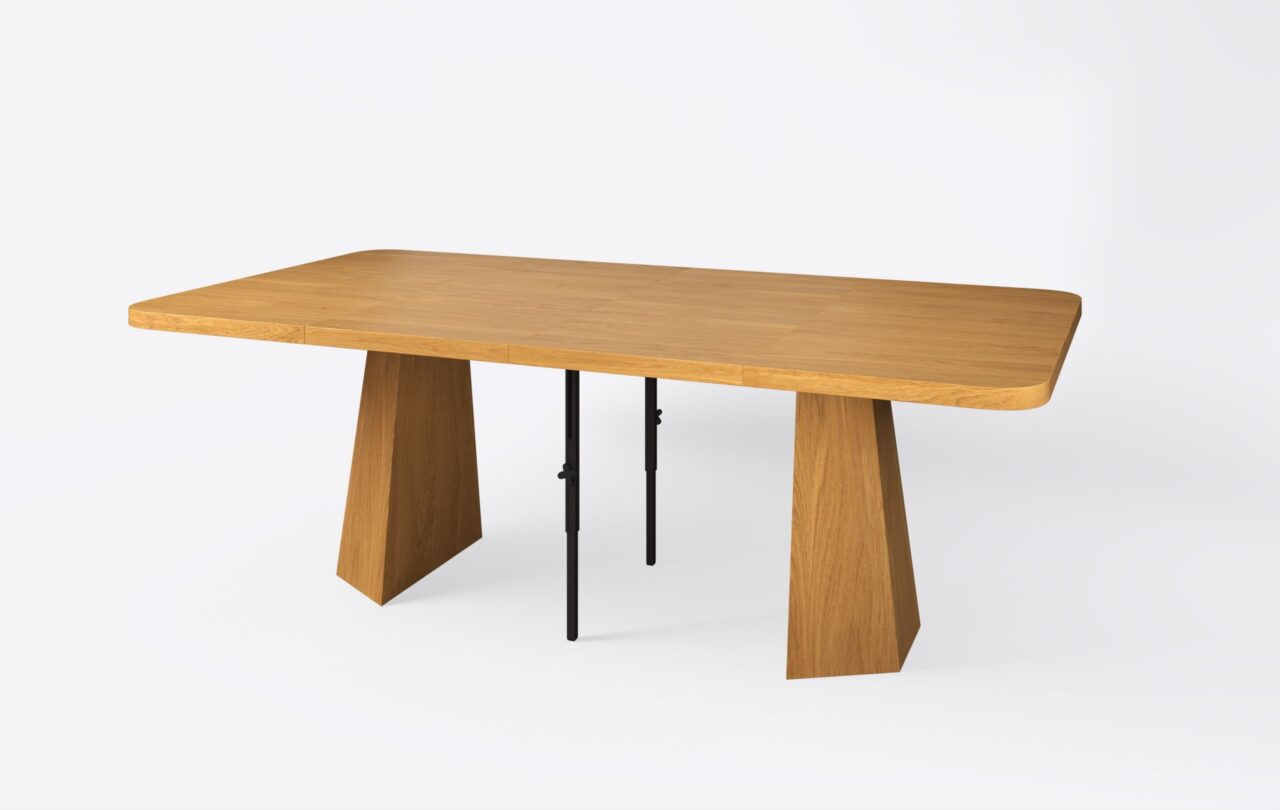 Jasny rozłożony stół na podstawie z dwoma wkładkami, wykonany z naturalnego forniru dębowego.